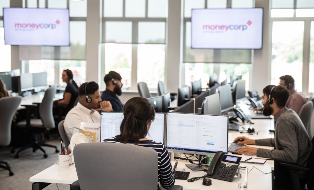 Software developer working in a busy office